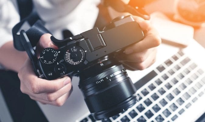 A person holding a camera and taking a picture.