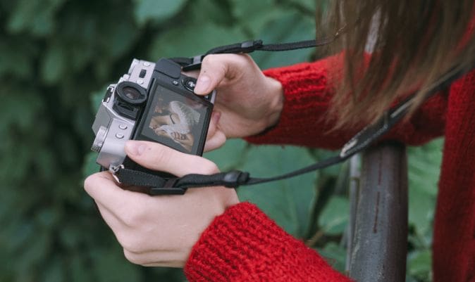 A person holding a camera in their hands.